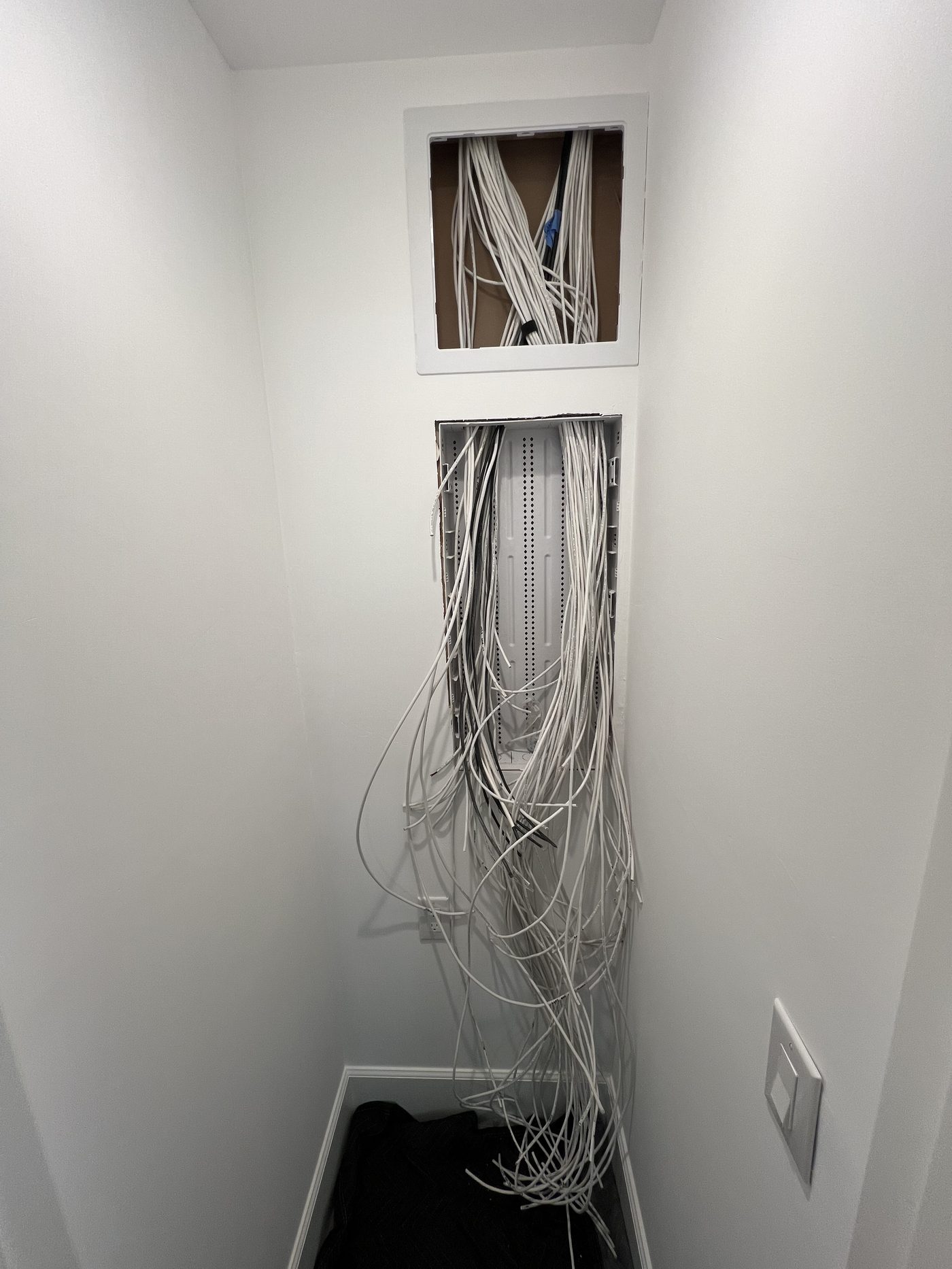 Low-voltage wiring closet with cable bundles ready for termination
