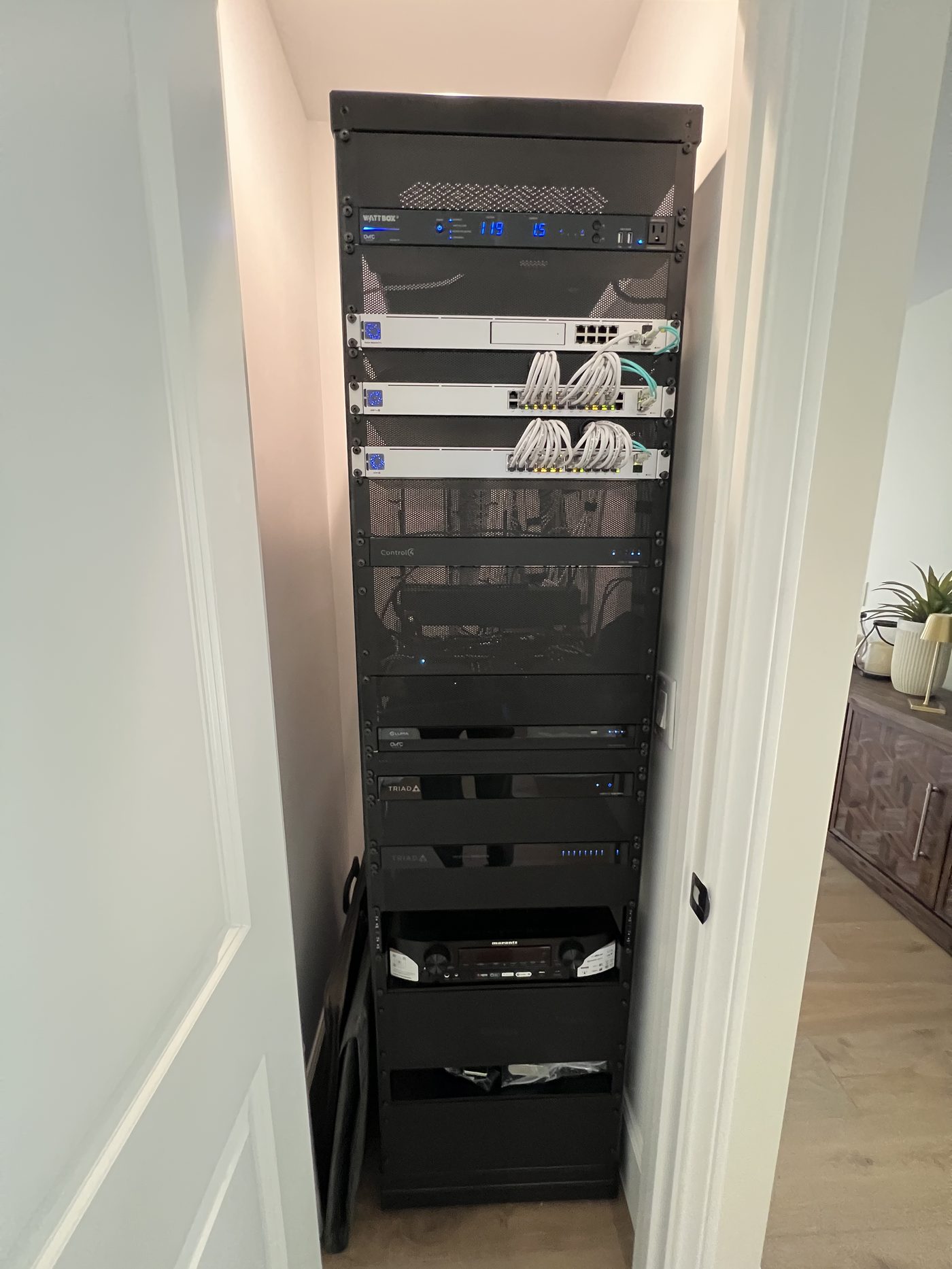 Equipment rack with WattBox power management, network switches, and Control4 automation